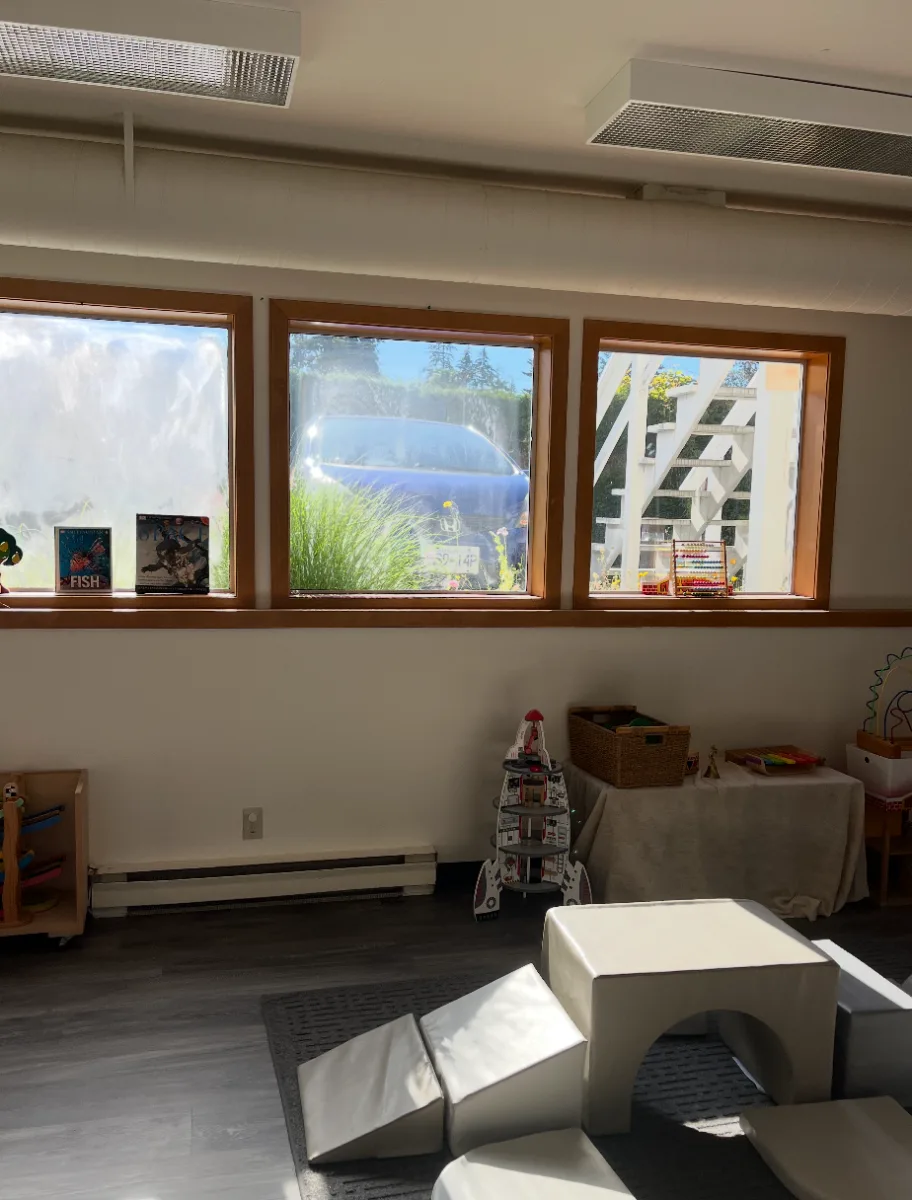 A light-filled classroom with big windows and soft play blocks