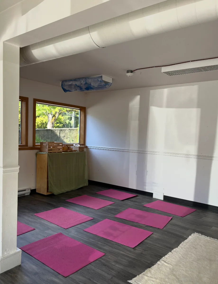 Our movement and yoga room with mats and a natural-wood shelf